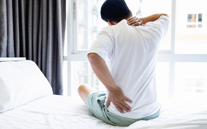 Young man with morning joint pain